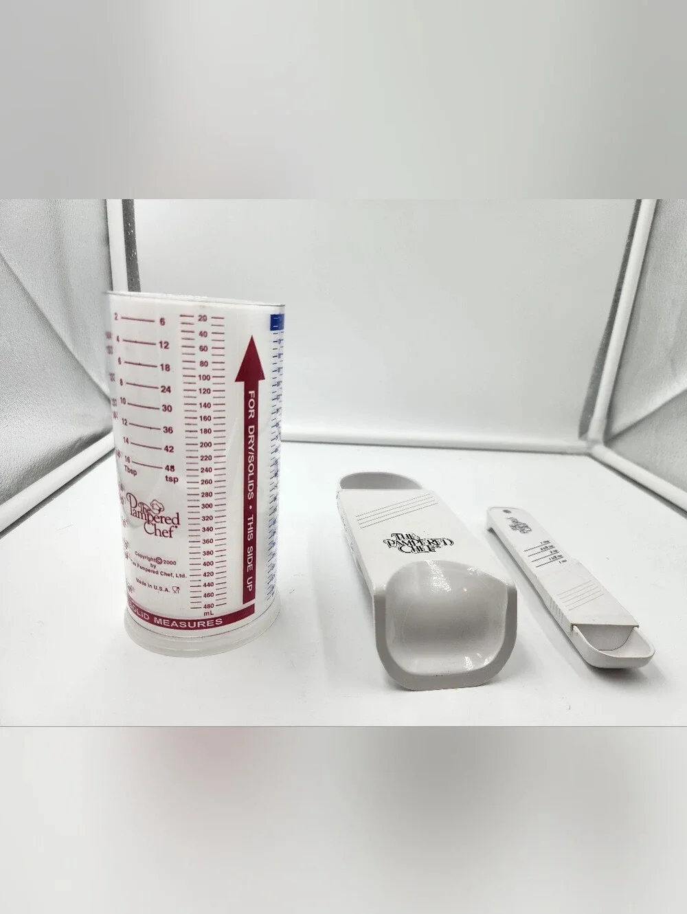 3 Pampered Chef measuring cups. A Measure All 2 Cup,a 1/2 Cup scoop, Tablespoon
